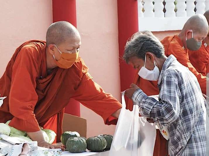 Ven. Dhammananda distributes food in front of her monastery. Image courtesy of the authorVen. Dhammananda distributes food in front of her monastery. Image courtesy of the author