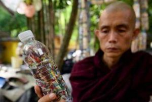 Sayadaw U Ottamasara holds a PET bottle filled with discarded plastic bags at Thabarwa Centre. Photo by Shew Paw Mya Tin. From swissinfo.ch