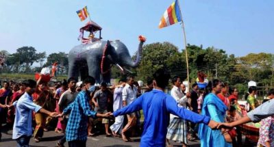 Devotees in a procession take an elephant image bearing robes to Buddhist monks at Rajban Vihar. From thedailystar.net