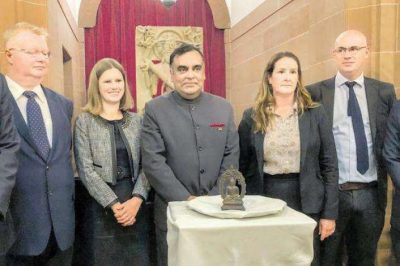 India’s high commissioner to the United Kingdom, Y. K. Sinha, centre, with the bronze Buddha statue. From livemint.com