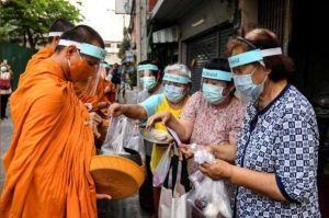 Monastics in Thailand on their alms round on 31 March. From reuters.com