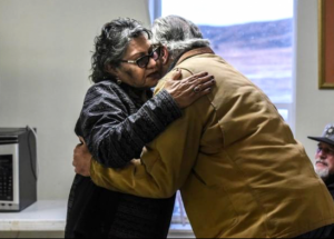 Dena Waloki, left, embraces Bradley Upton during his apology to descendants of victims of the Wounded Knee Massacre. From reuters