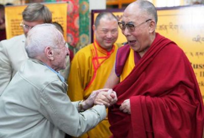His Holiness the Dalai Lama greets Russian cognition theorist Prof. David Dubrovsky. Photo by Tenzin Choejor. From dalailama.com