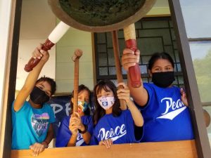 Children ring a bell for the International Day of Peace