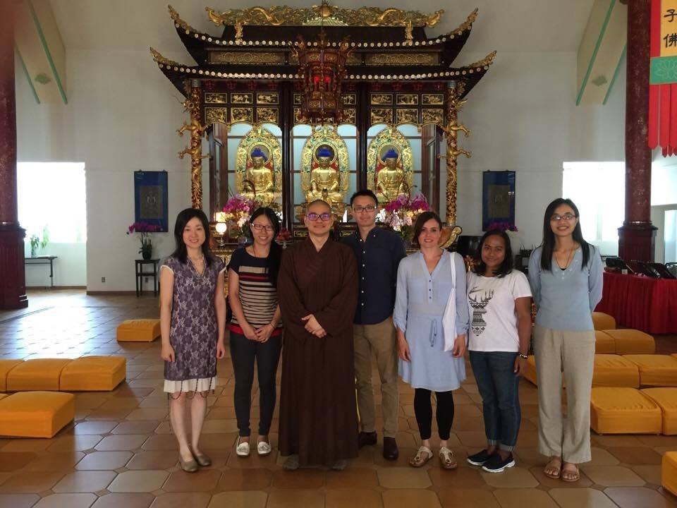 Ven. Tian Wen with temple visitors and Raymond Lam at TLKY Canada's main hall. From Buddhistdoor Global