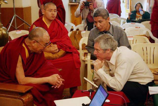 Alan listening to H.H. the Dalai Lama at a Mind and Life Conference in 2004. Source: Mind and Life Institute 