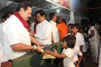 Pres. Mahinda Rajapaksa at Poson activities. From: www.coloumbopage.com