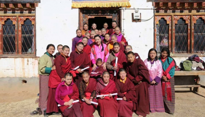 Her Majesty, the Queen Mother, Ashi Tshering Yangdon Wangchuck, center, and Bhutan Nuns Foundation executive director Dr. Tashi Zangmo, far left, pose with some of the nuns who have received education and training thanks to the BNF. Image courtesy of the Bhutan Nuns Foundation