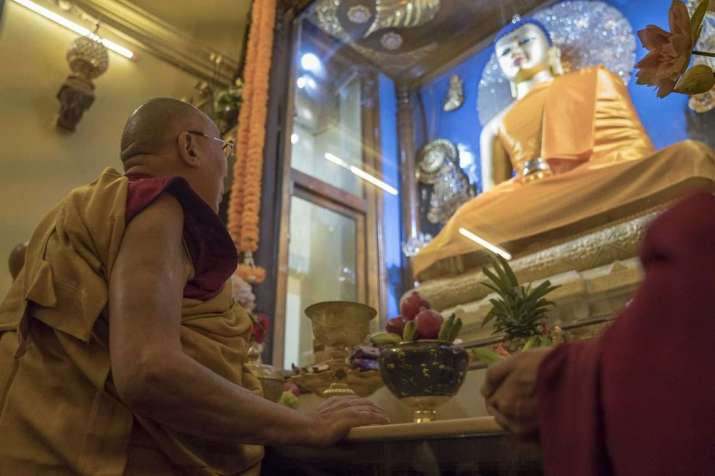 The Dalai Lama views the Buddha statue inside Mahabadhi Temple. From dalailama.com