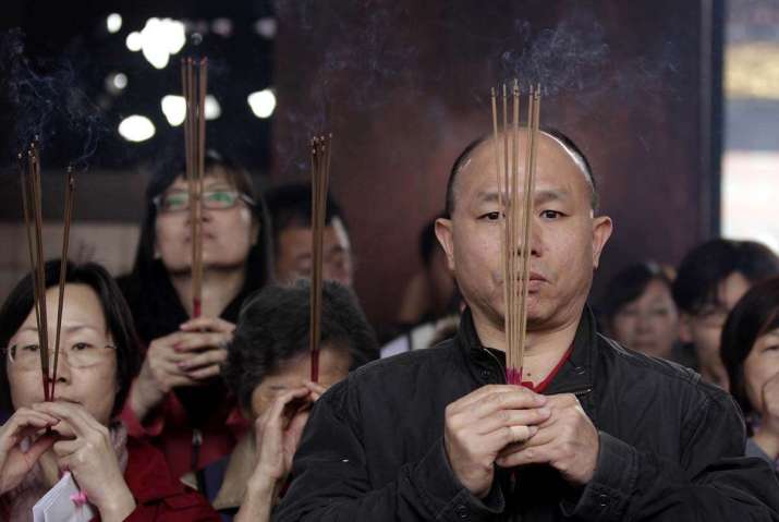 Devotees burn joss sticks at a Buddhist temple. From baltimoresun.com