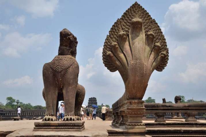 Seven-headed <i>naga</i>, right, next to a guardian lion at Angkor Wat, Cambodia. From tour-to-cambodia.com