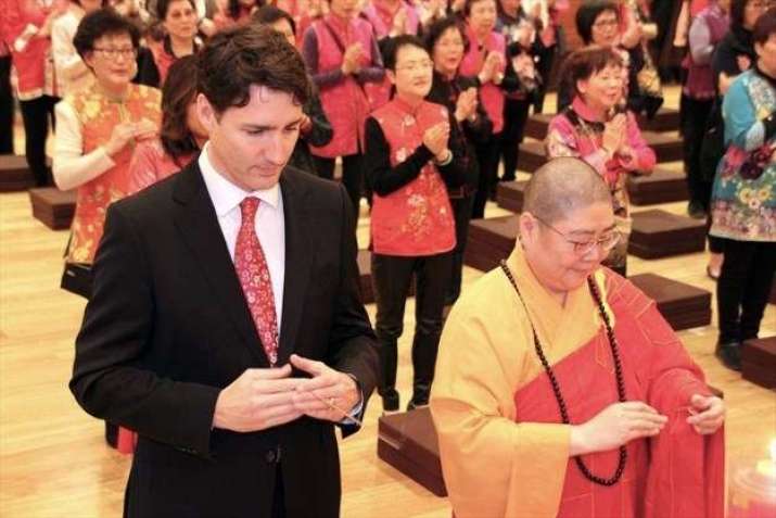Canadian Prime Minister Justin Trudeau takes part in a New Year prayer service at the Fo Guang Shan Temple during a visit to Mississauga. From mississauga.com