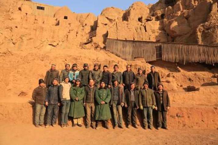 Archeologists pose at the Tuyugou Grottoes. Photo courtesy of Xia Lidong. From ecns.cn