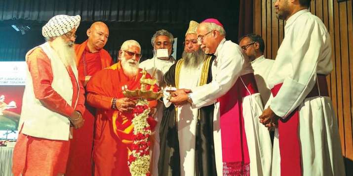 Religious leaders light a lamp at the start of the interfaith meeting. From navhindtimes.in
