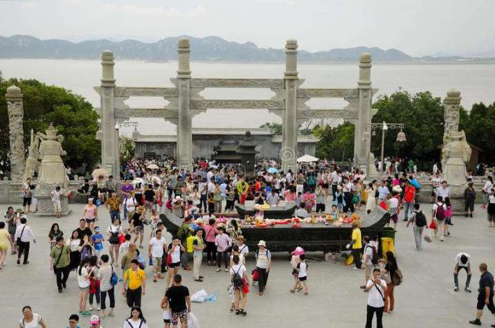Tourists make offerings at a Guan Yin statue on Putuo Shan. From dreamtime.com