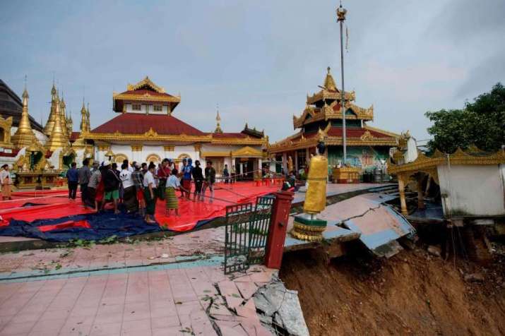 Local residents save a Buddha statue after a landslide damaged the hilltop Kyeik Than Lan Pagoda in Myanmar’s Mon State on Monday. From nst.com.my