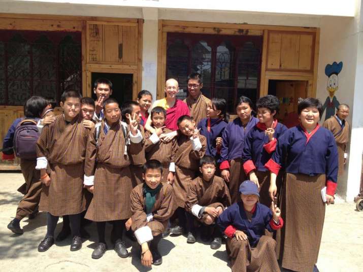 Pema Deki with some of the children she helps with her charity. From facebook.com