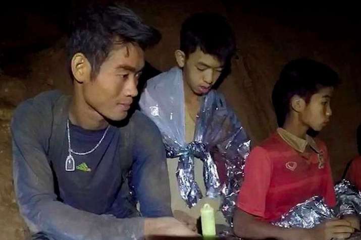 Ekaphol, left, taught the trapped boys to meditate to stay calm in the cave. From vox.com