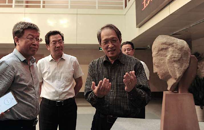 The carved head was donated to Shanxi Museum by John S. C. Wang, far left, and his wife. From china.org.cn