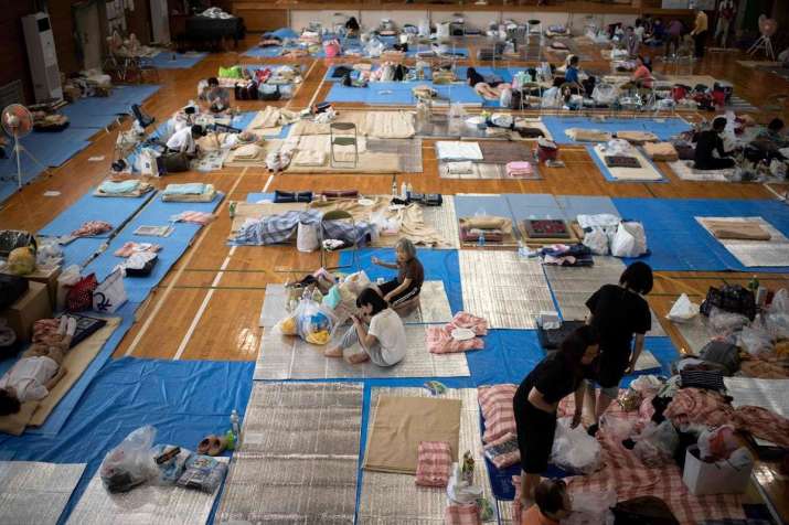 Evacuees settle at a makeshift shelter in the riverside town of Mabi, Okayama Prefecture. From theguardian.cm