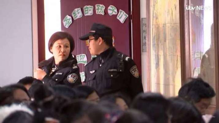 Police officers monitor a church service in China in March 2018. From christianpost.com