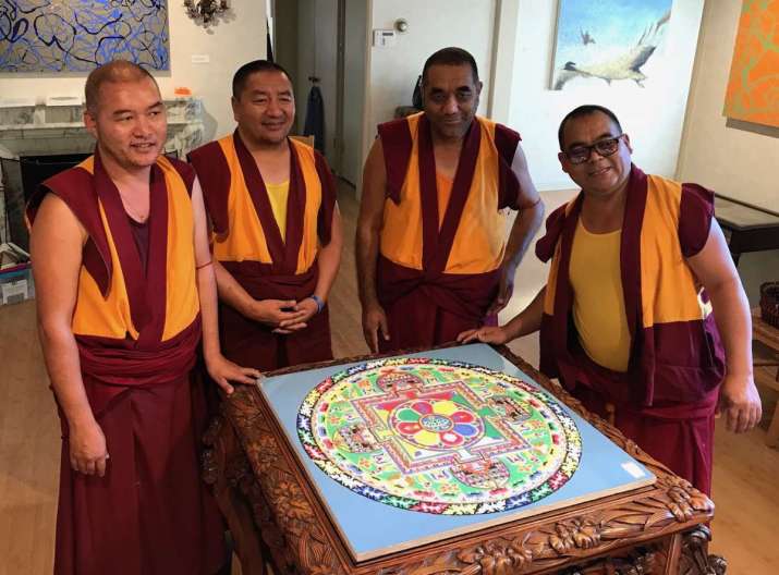 Lama Kunkhen, Geshe Jampa, Geshe Tsewang Dorje, and Geshe Kunchok stand by the completed sand mandala at the Storrier Stearns Japanese Garden in Pasadena, California. Photo by the author
