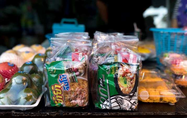 Prepackaged foods, sold to be given to monks, often include soft drinks, boxed juices, and sweet snacks. From nytimes.com