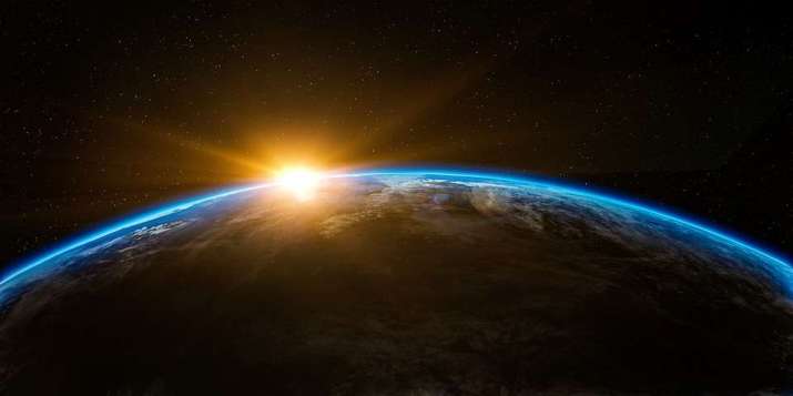 The sun rising behind planet Earth. From pixabay.com