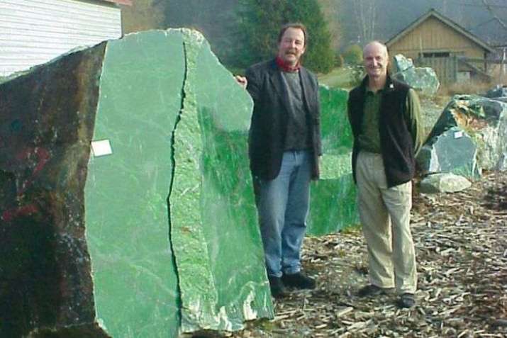 Ian Green next to the giant jade boulder in Canada. From abc.net.au