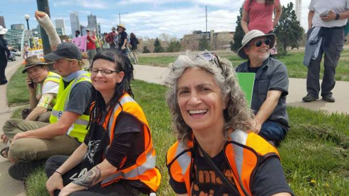 Lisa Widdekind (front) with David Loy behind her and other protesters in Denver. Image from facebook.com