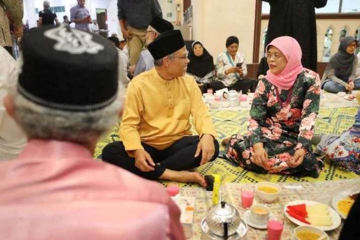 Singaporean President Halimah Yacob and Minister-in-charge of Muslim Affairs Masagos Zulkifli join Muslim faithful in breaking their fast at Masjid Hajjah Fatimah on 7 May. From straitstimes.com