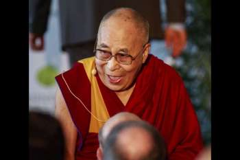 The Dalai Lama laughs during a press conference in 2017. From sandiegotribune.com