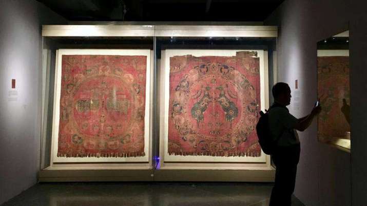 Silk brocades with large circular panels and pearls. From chinadailyhk.com