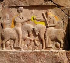 Fig. 7. Investiture relief at Naqs-I Rustan, Ahura Mazda hands the beribboned diadem to Ardasir I (224-42 CE). Image courtesy of Prof. Osmund Bopearachchi