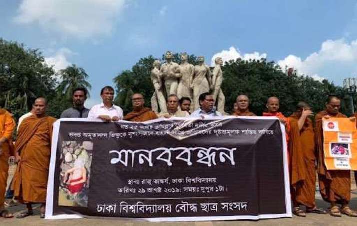 Dhaka University Buddhist Students’ Union organizes a human chain at the Anti-Terrorism Raju Memorial Sculpture on the Dhaka University campus. From dhakatribune.com