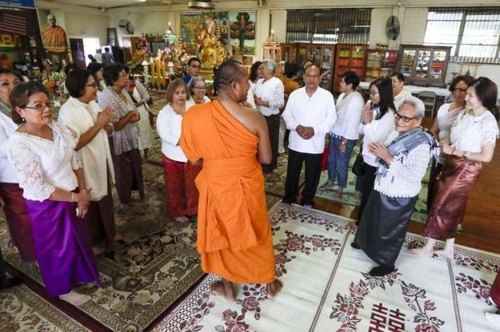 Ven. Thet Sim stands among supporters at Khemara Buddhikarama. From latimes.com