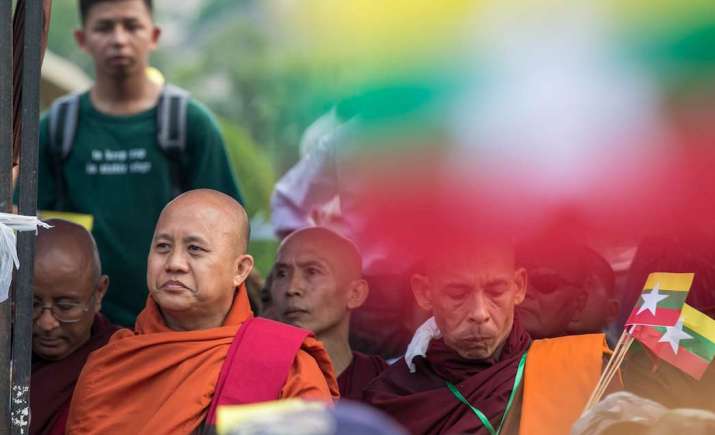 Buddhist monk Ashin Wirathu, second left, formerly a key figure in the ultra-nationalist Ma Ba Tha organization and now a fugitive, speaks during a rally in support of the military in May. From uca.news