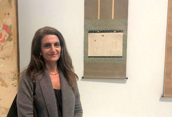 The author beside <i>Butterflies and Poem</i> by Japanese Buddhist nun Otagaki Rengetsu in the Los Angeles County Museum of Art. Image courtesy of the author