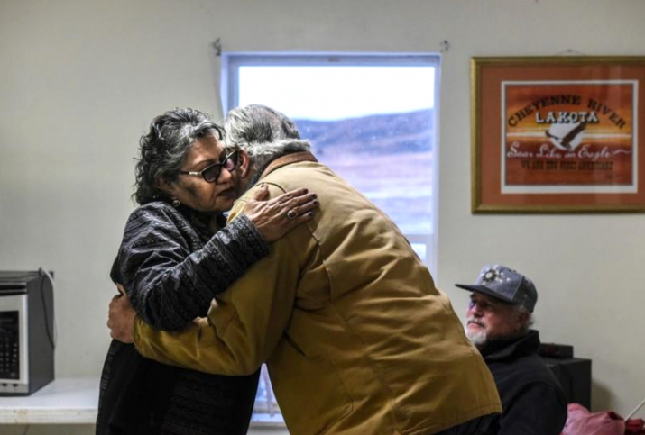 Dena Waloki, left, embraces Bradley Upton during his apology to descendants of victims of the Wounded Knee Massacre. From reuters