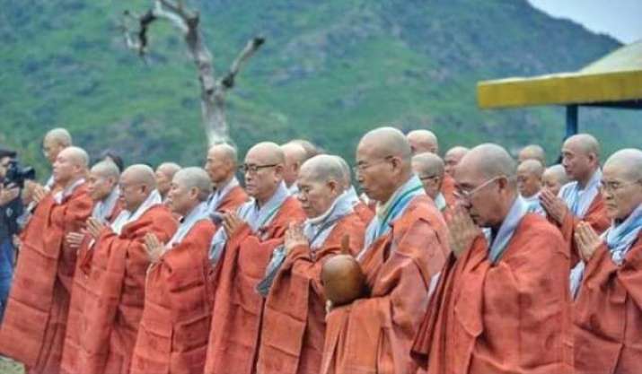 Korean Buddhist monks perform a ritual at a historic site in Haripur.  From tribune.com.pk