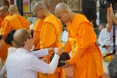 Monks receive alms during a Kathina ceremony at Wat Phra Dhammakaya Nederland. From facebook.com