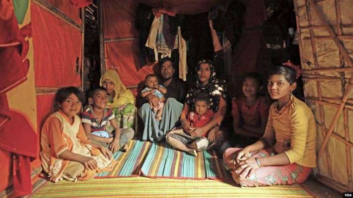 Abu Sayod, and his wife, Anuwara Begum in their shelter at Kutupalong refugee camp in Cox’s Bazar. Their children, from left to right: Aru Juma, Anayet Husson, Aziz Fatima, Saiful Islam, Jahed Husson, Tasmin Fatima, and Nur Fatima. Photo by Hai Do. From voanews.com