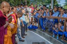 The Dalai Lama greets schoolchildren on Vesak in 2016. From dalailama.com