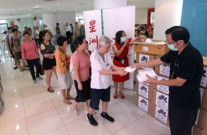 Distributing face masks in Malaysia. From annx.asianews.network