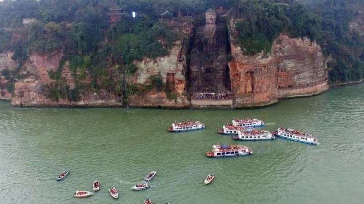 Tourist boats visit the Leshan Giant Buddha. From bbc.com