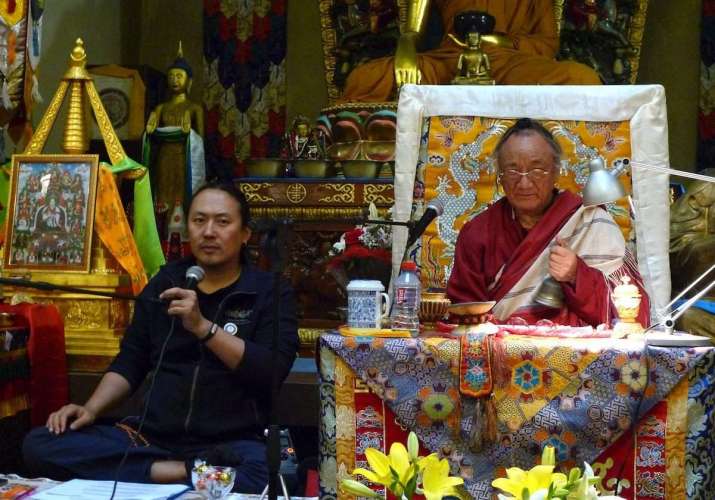Mitruev interpreting during a teaching by the late Lama Pema Dorje Rinpoche. Image courtesy of Bem Mitruev