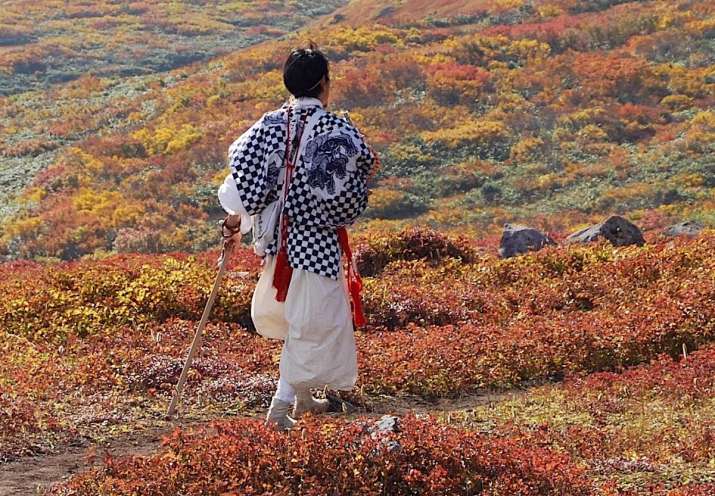A Shugenja in the Haguro Shugendo tradition traversing Gassan, one of the Three Sacred Mountains of Dewa. Photo by Alena Eckelmann
