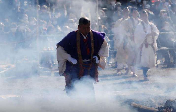 A monk walks over hot coals at the 2021 <i>hiwatari matsuri</i> festival. From reuters.com